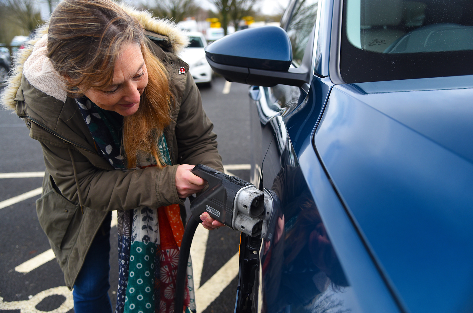 Plugging in an Audi E-tron electric car