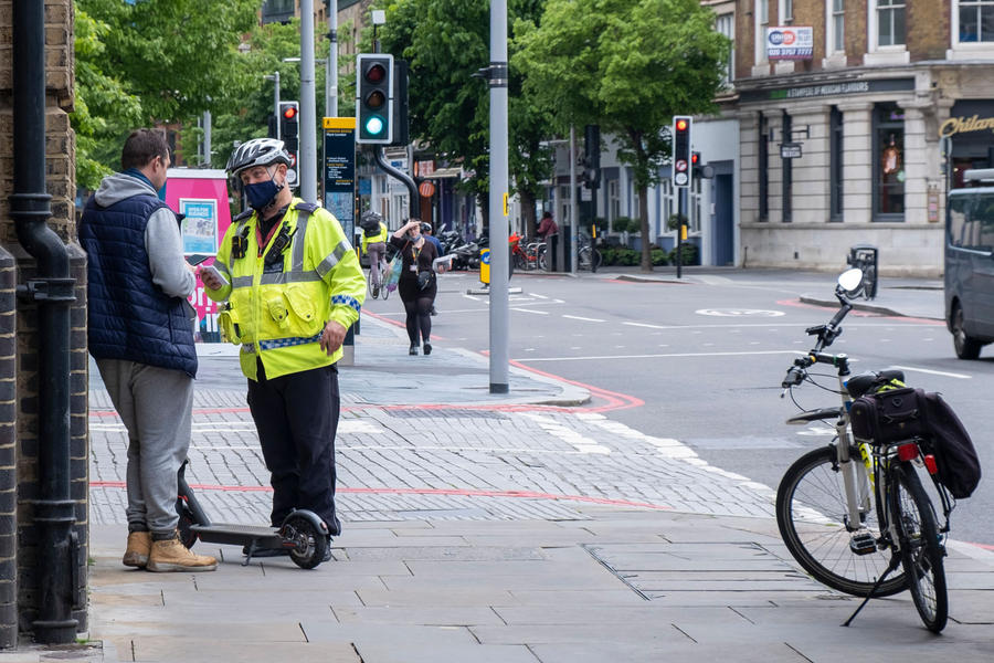 Police officer talking to e-scooter rider