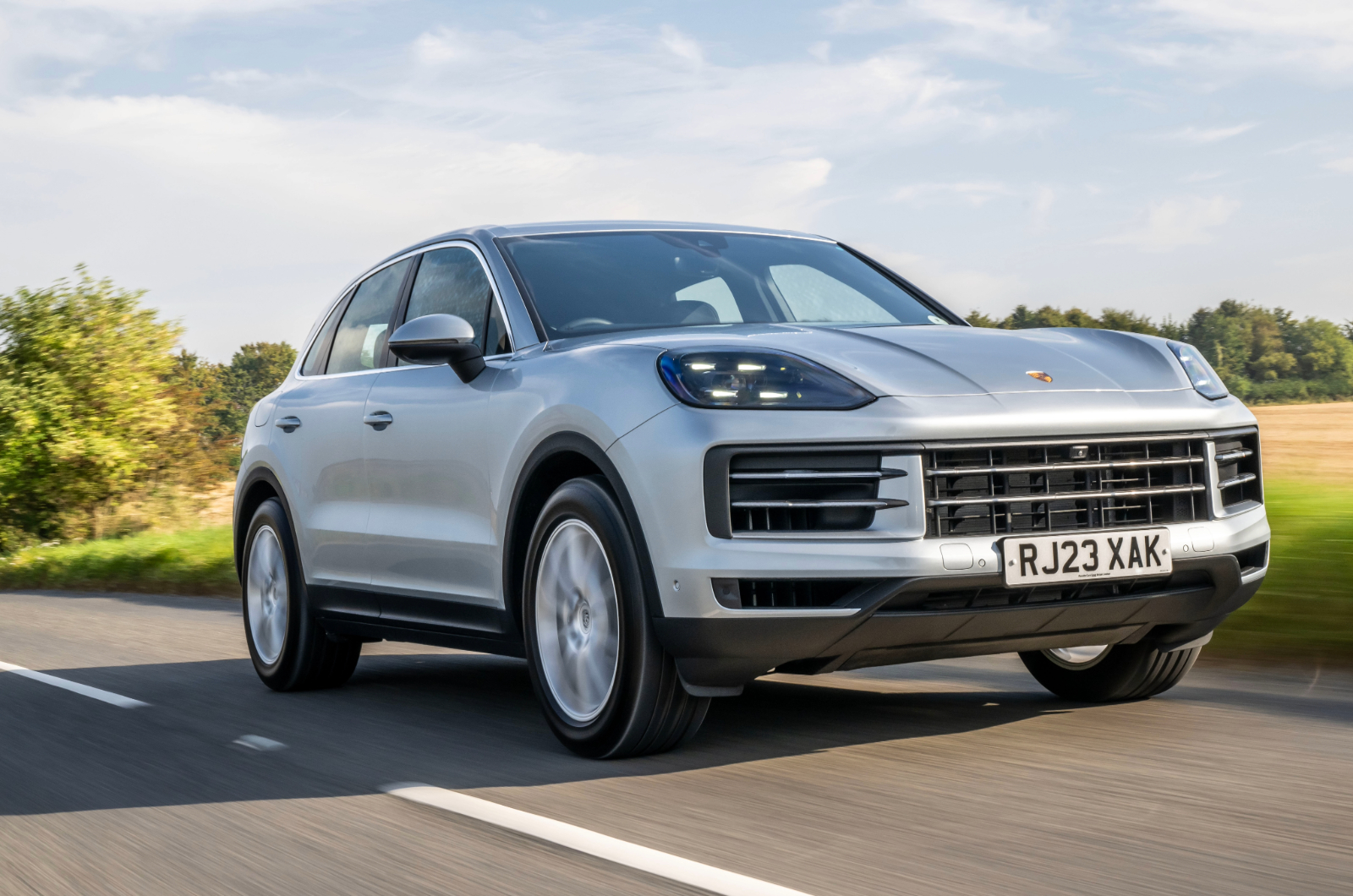 Silver Porsche Cayenne front driving