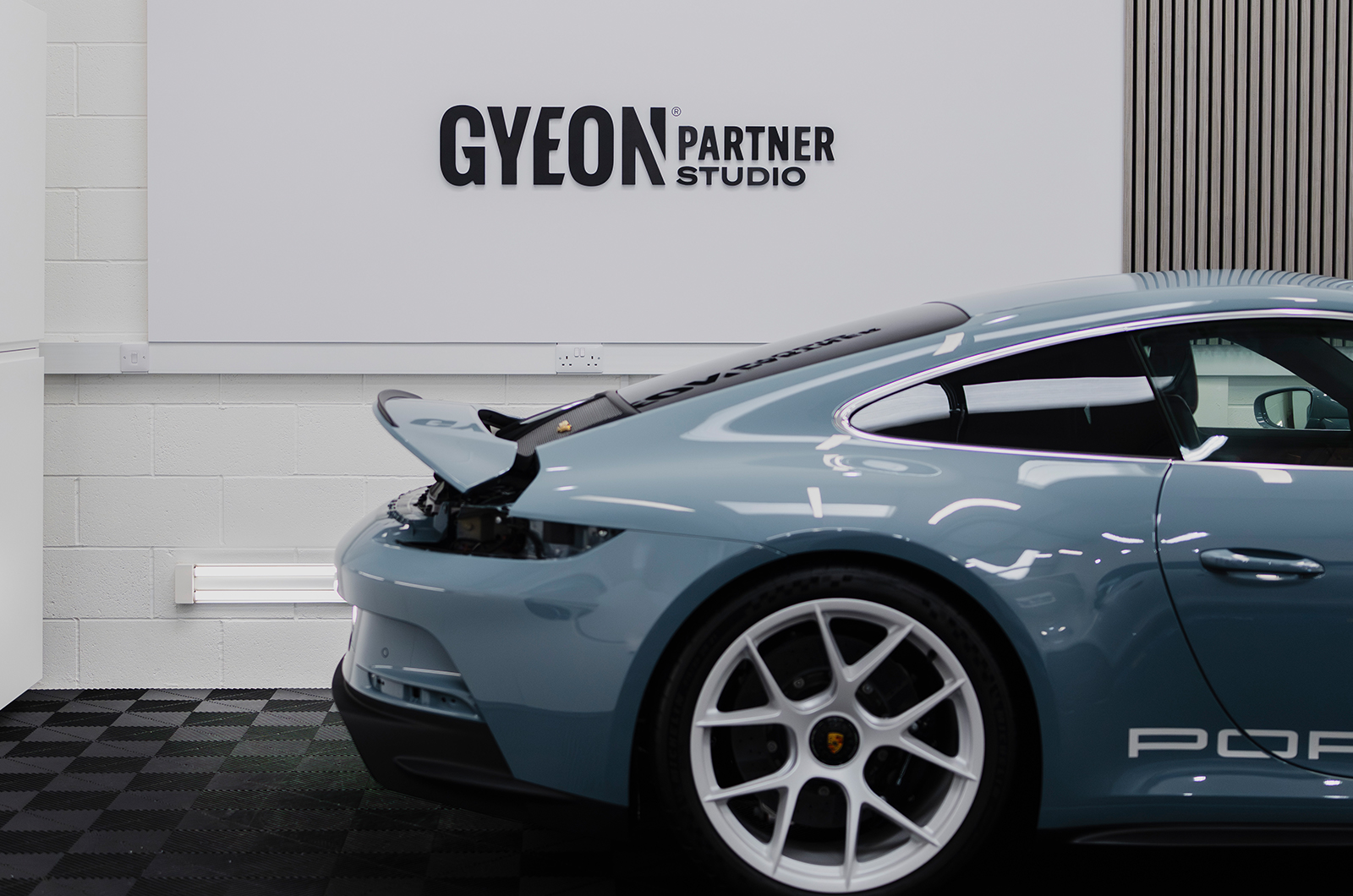 The rear of a Porsche shines in a Gyeon partner studio