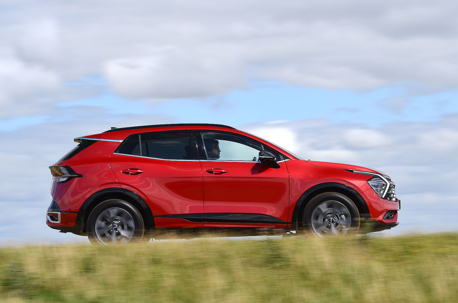 Red Kia Sportage right driving
