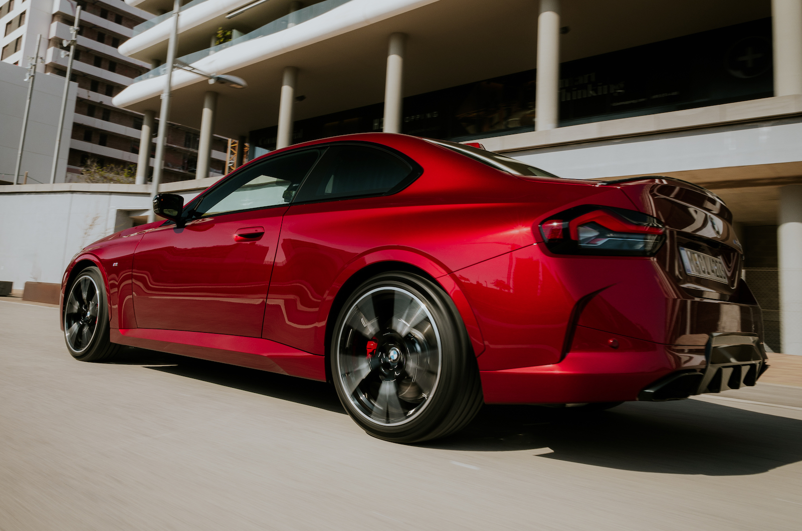 Red BMW 2 Series rear left driving