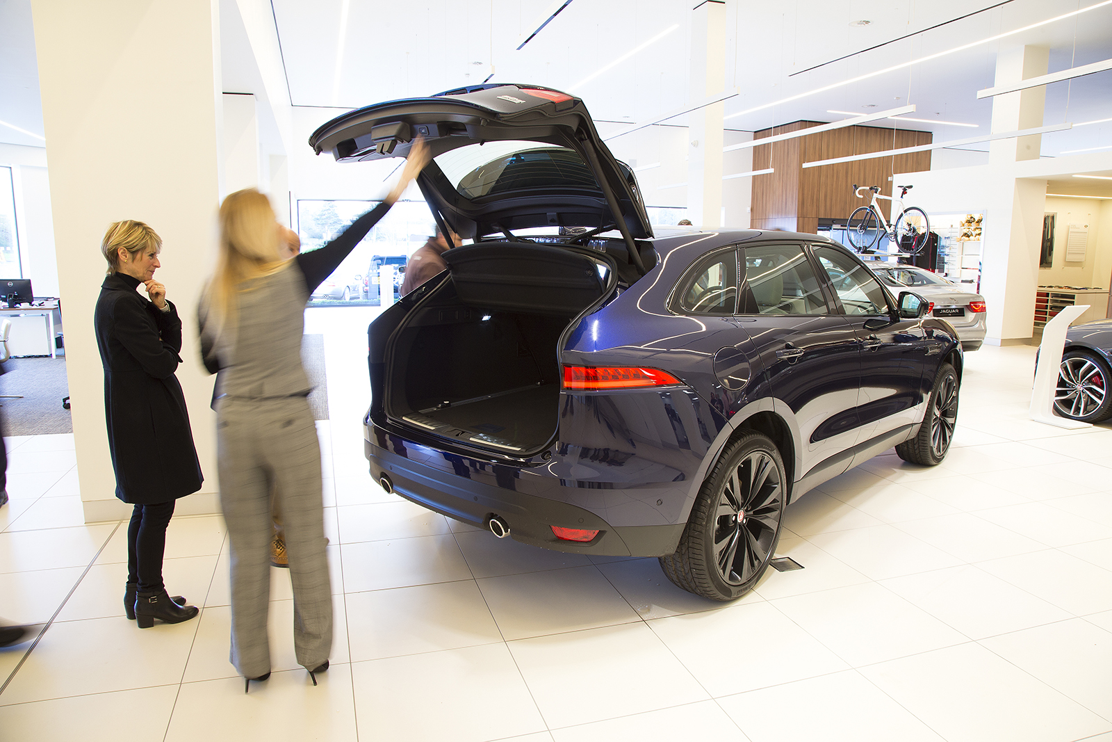 A buyer inspecting a car for sale at a dealership