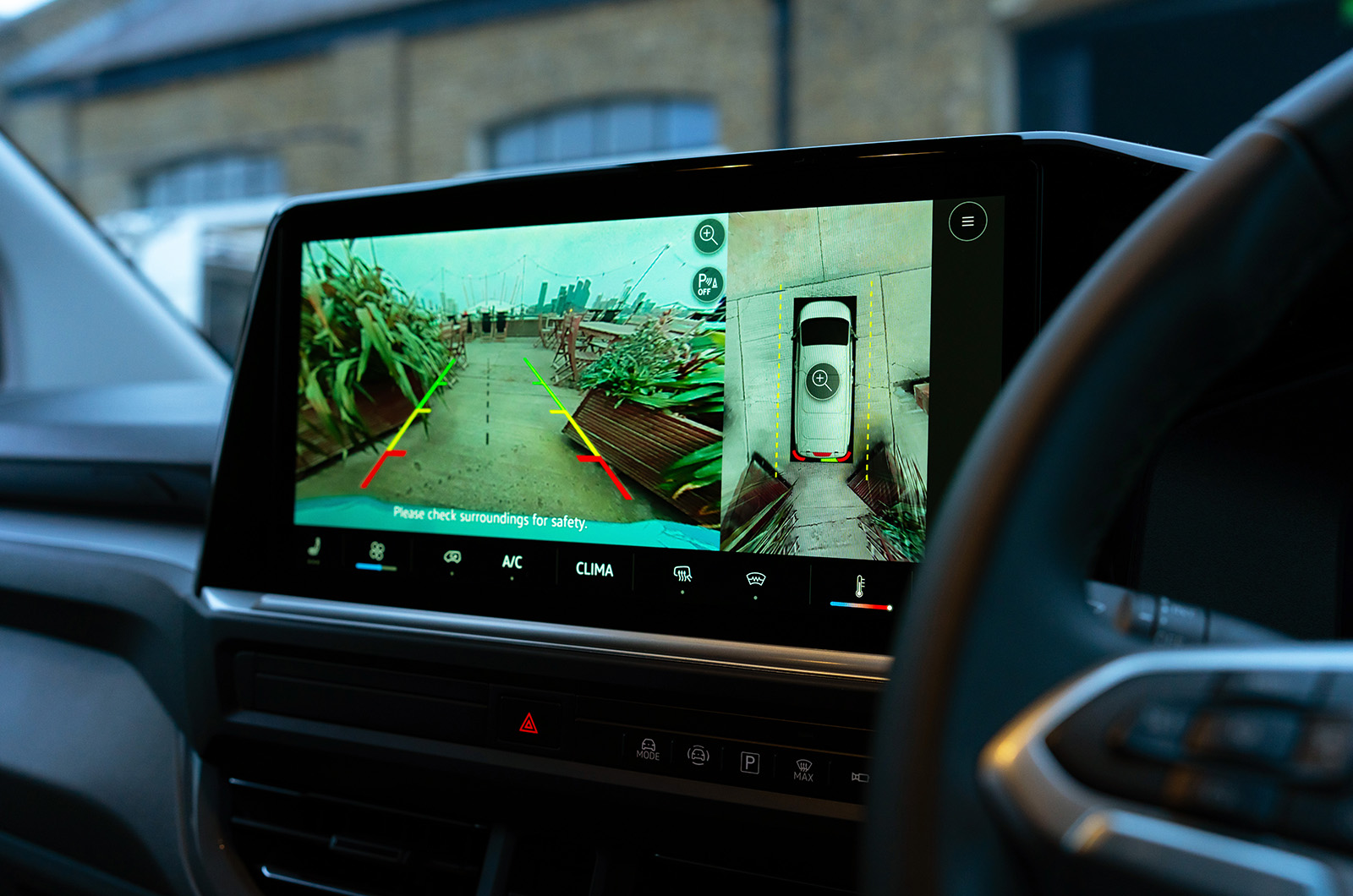 Close-up shot of the infotainment screen in a VW Transporter showing the reversing camera