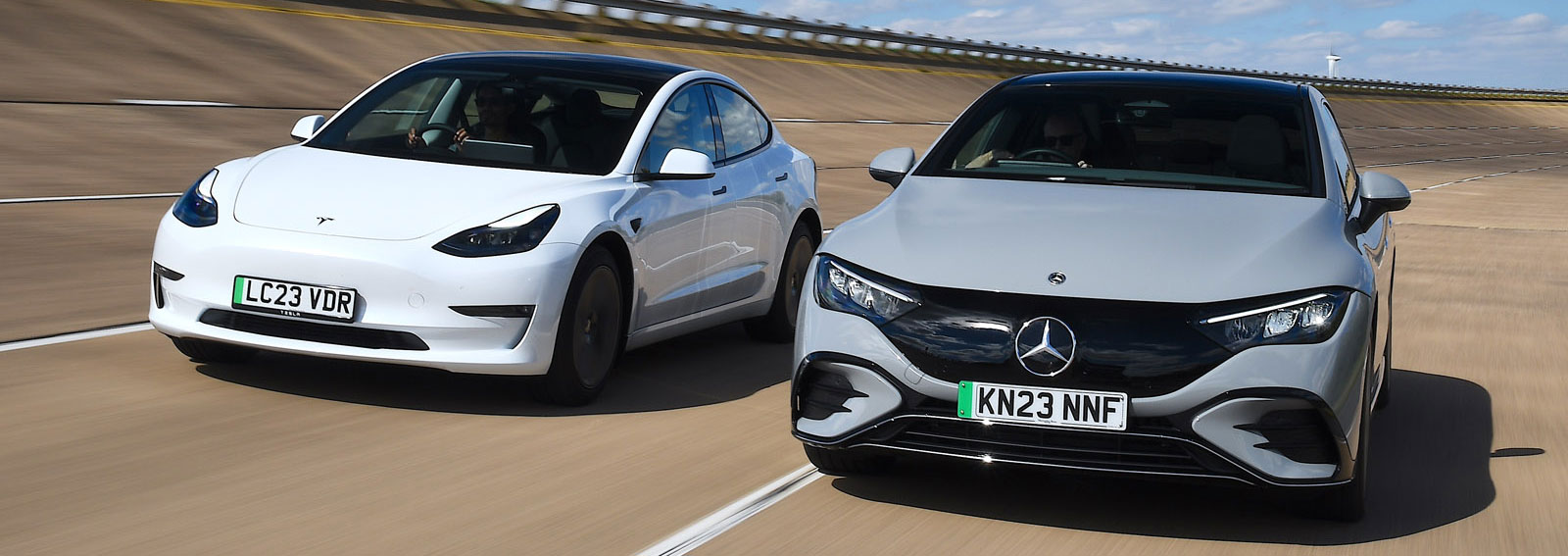 Tesla Model 3 and Mercedes EQE driving front