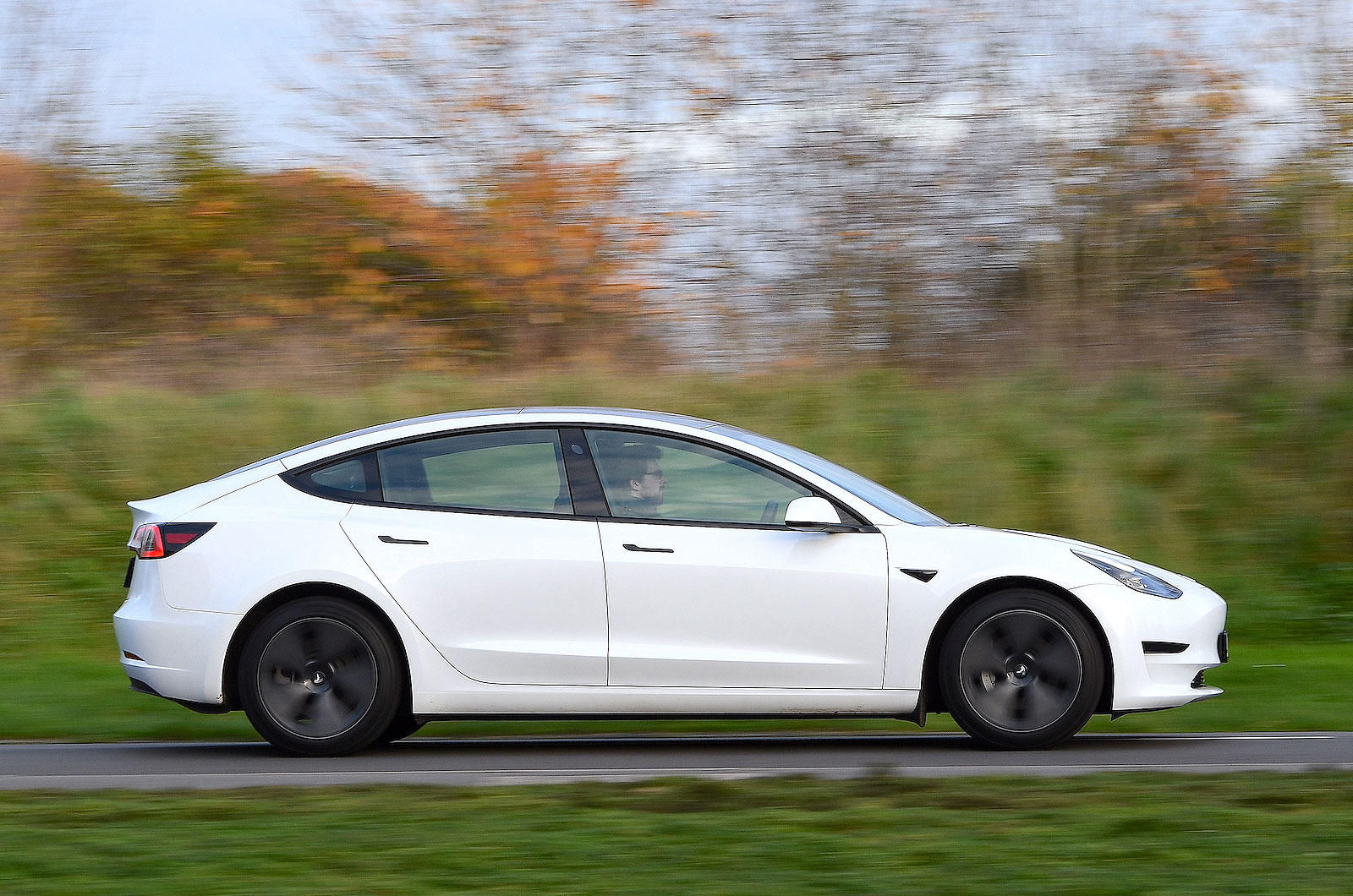Red Tesla Model 3 right driving