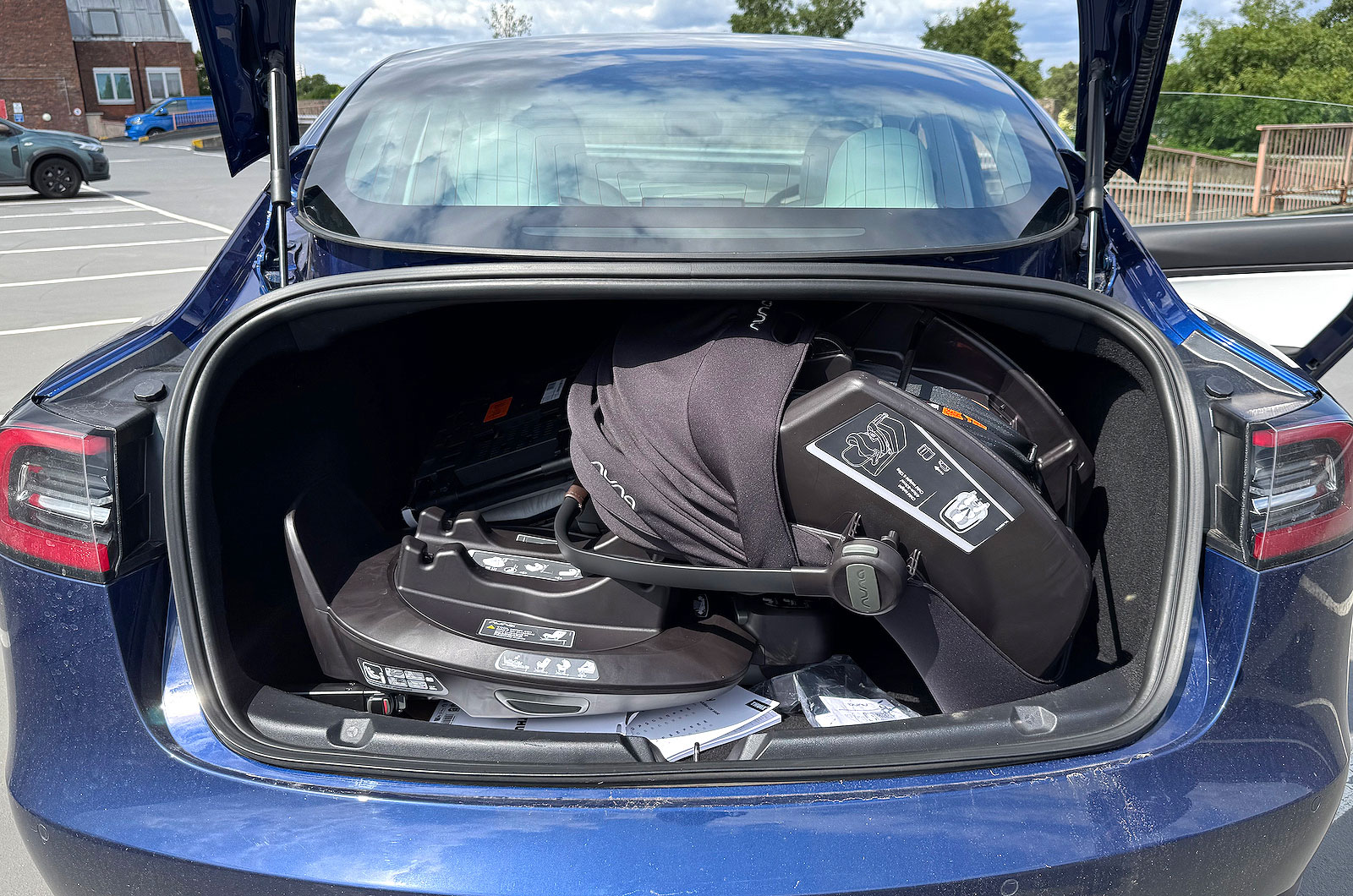 Tesla Model 3 with child seats in the boot
