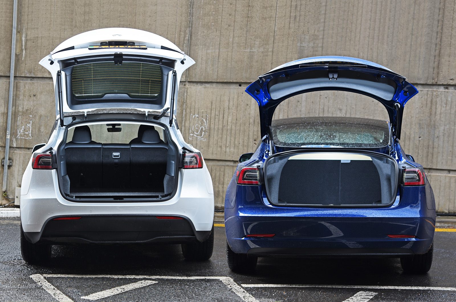 Tesla Model Y and Tesla Model 3 with boots open