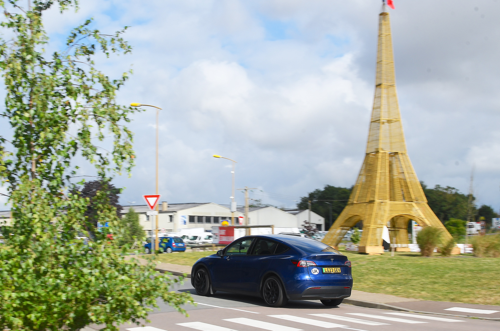 Tesla Model Y driving past Eiffel Tower replica