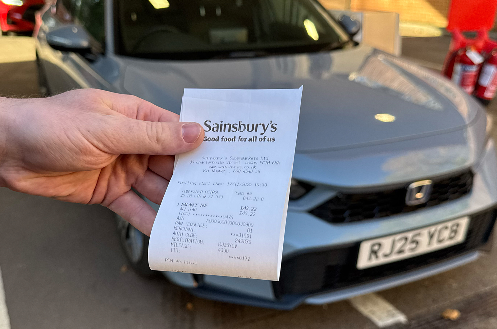 Tom holding the receipt for the Honda Civic refuel