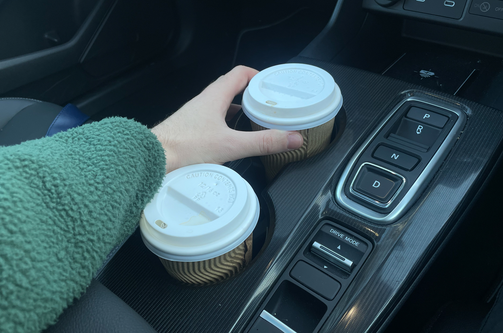 Tom using cup holders in Civic