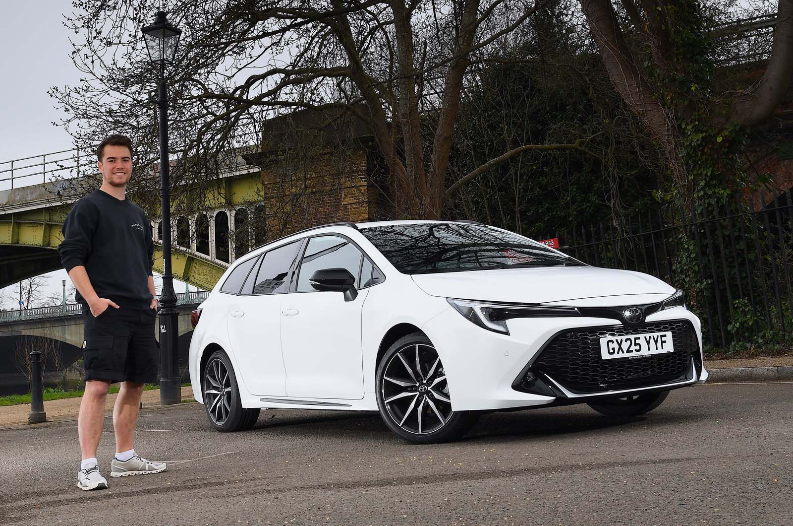 Jonty Renk standing by his Toyota Corolla Touring Sports long-term test car