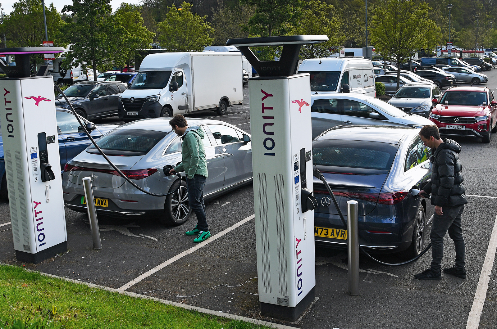 Two Mercedes EQEs charging at motorway services