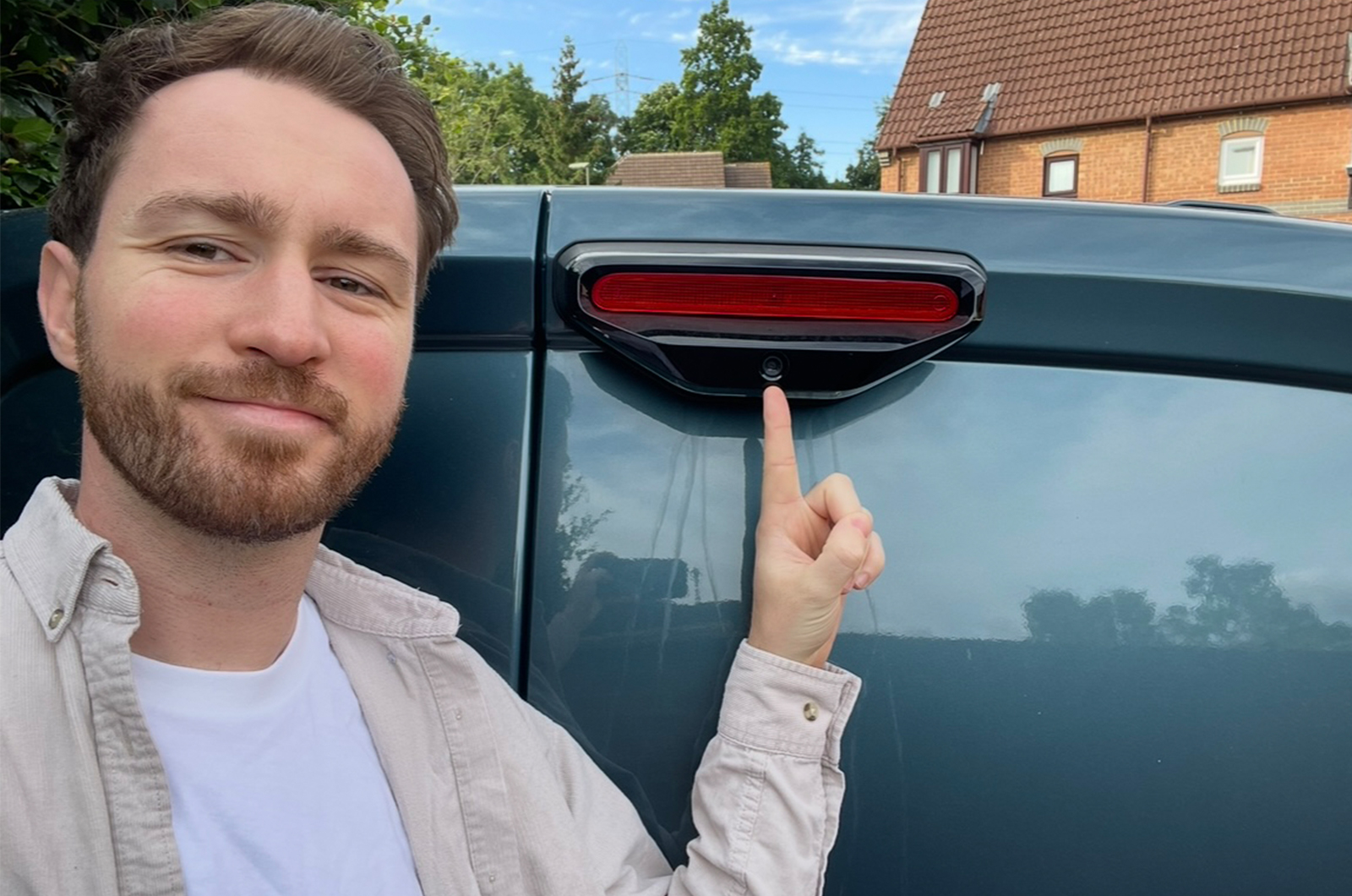 Tom pointing at the Fiat Doblo rear view camera