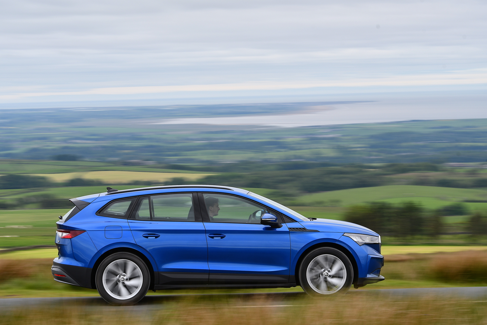 Used Skoda Enyaq 2021-present side driving blue