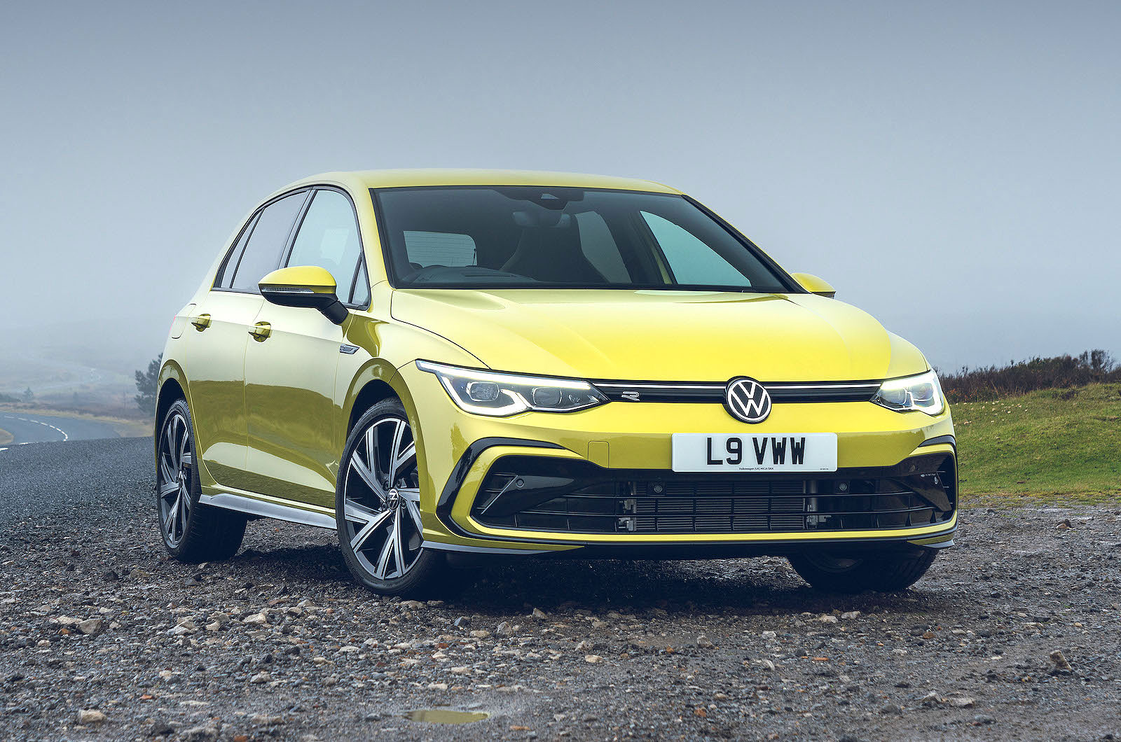 Yellow VW Golf front right static