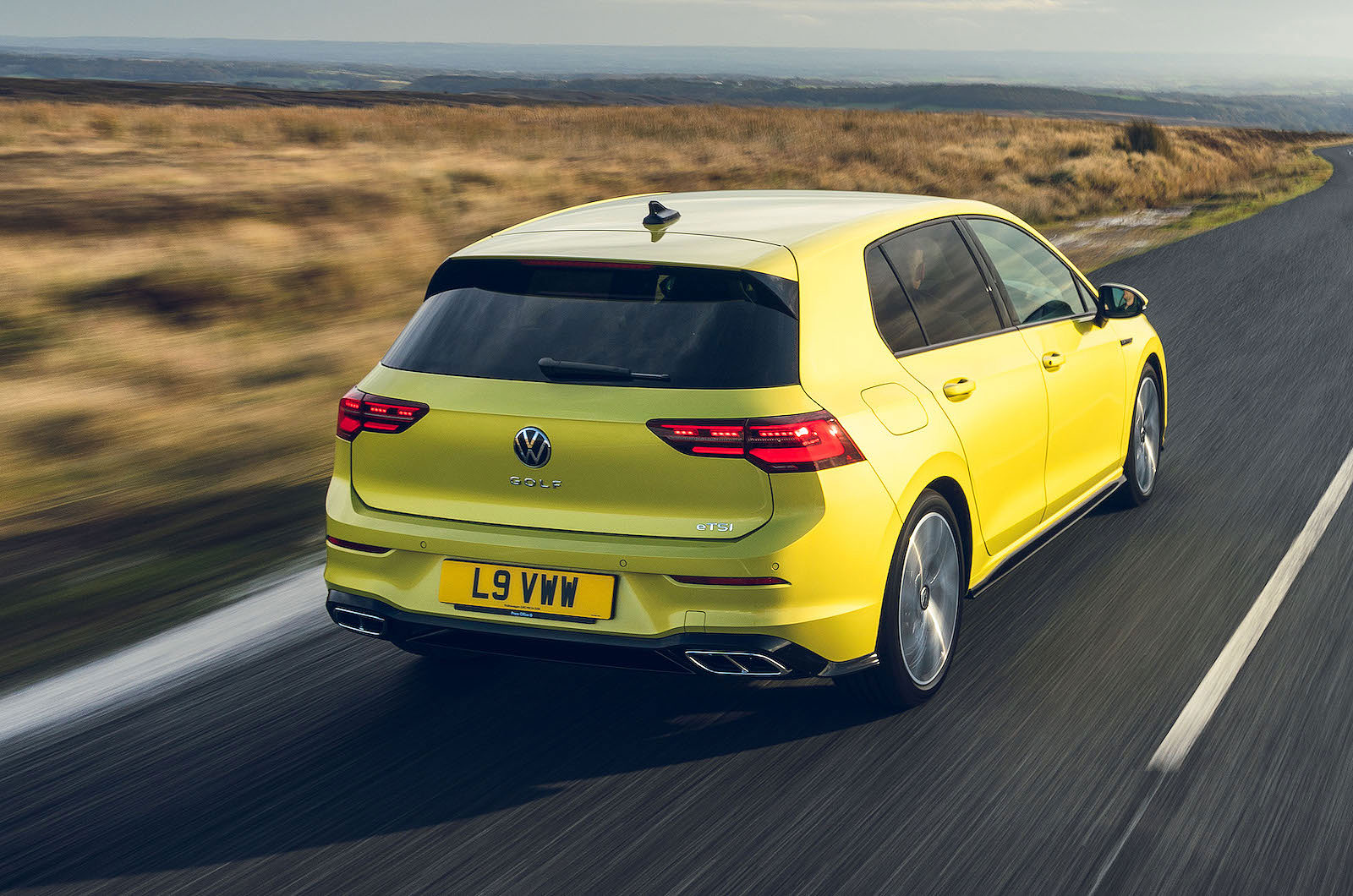 Yellow VW Golf rear right driving