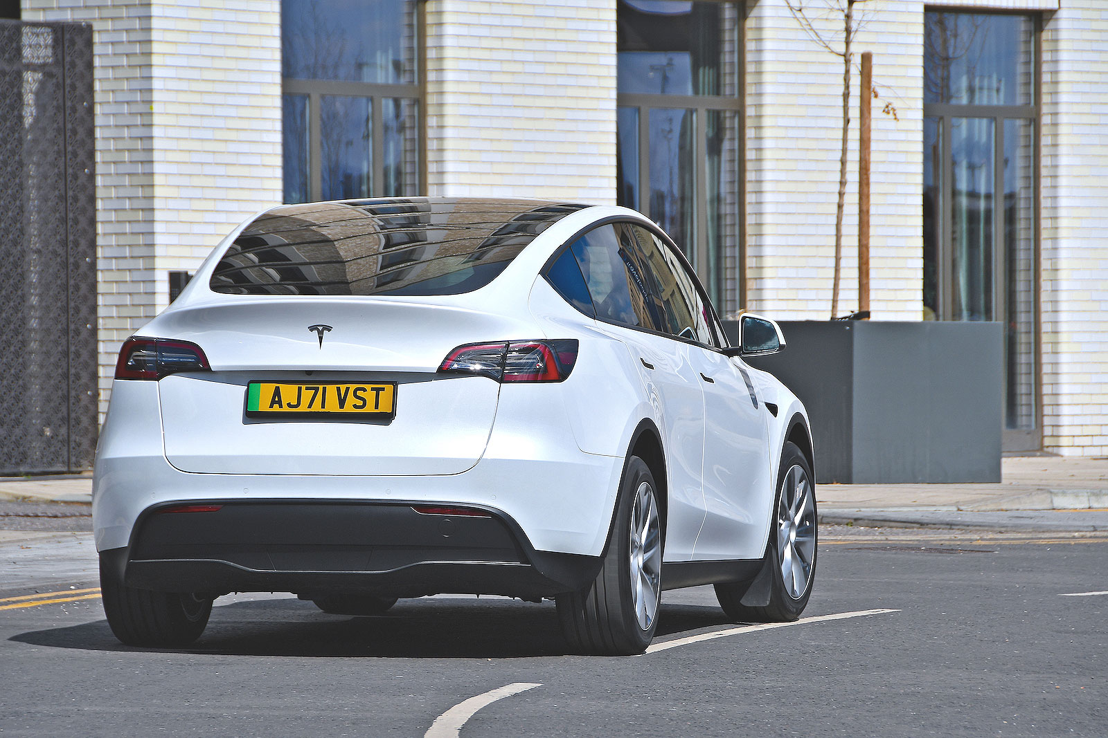 White Tesla Model Y rear cornering