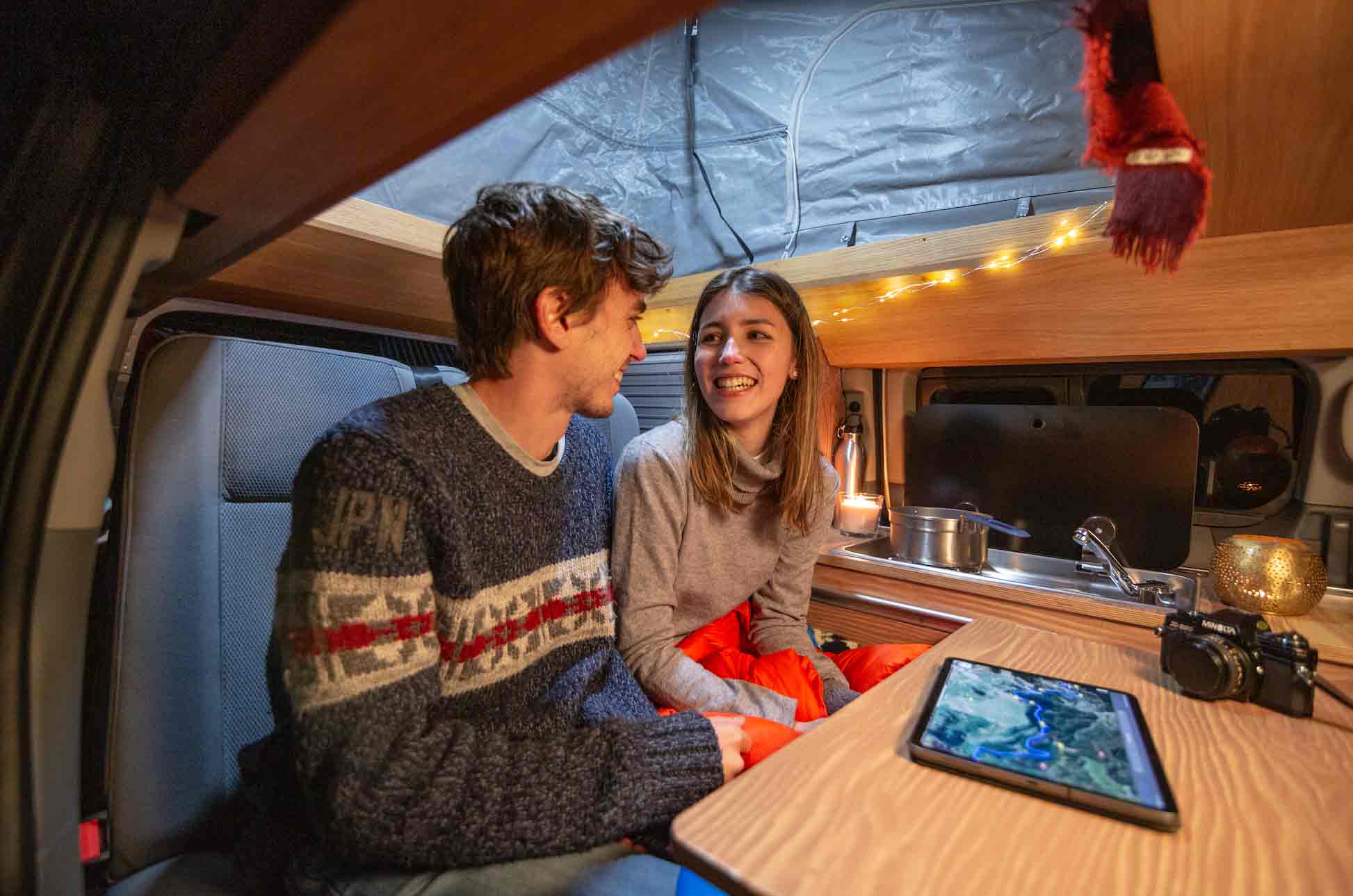 Couple sitting inside a campervan