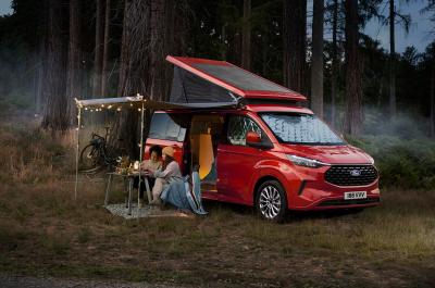 Ford Transit Nugget parked up with people sat under awning