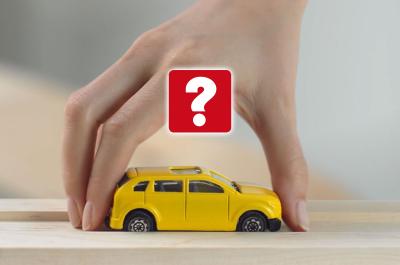 Hand picking up a toy car