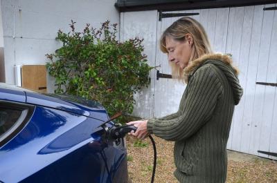 Best home EV chargers - Claire Evans plugging in Andersen home EV charger