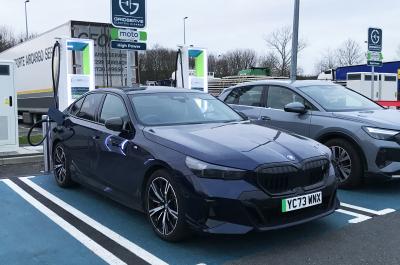BMW i5 LT charging at motorway services