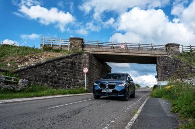 BMW X3 LT driving under bridge in Peak District