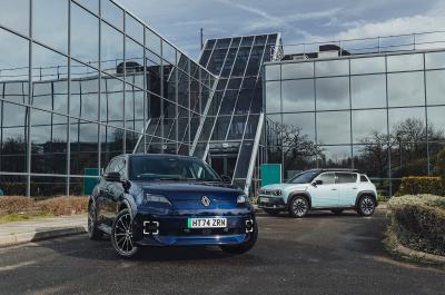 Blue Renault 5 and Renault 4 parked in front of a glass building