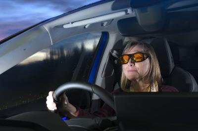 driver wearing anti-dazzle night time driving glasses