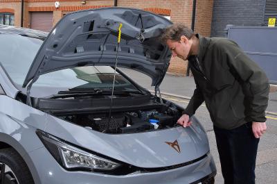 James Tute looking under the bonnet of a Cupra Born electric car