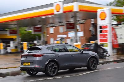 Grey Cupra Formentor driving past a Shell petrol station