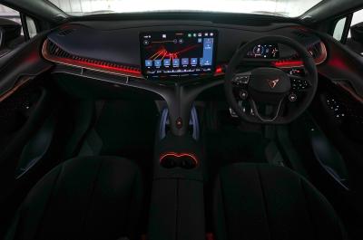 Wide interior shot of a CUPRA Tavascan dash area with ambient lighting