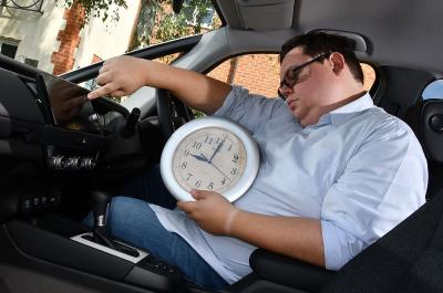 Darren Moss holding a clock in a Honda Jazz