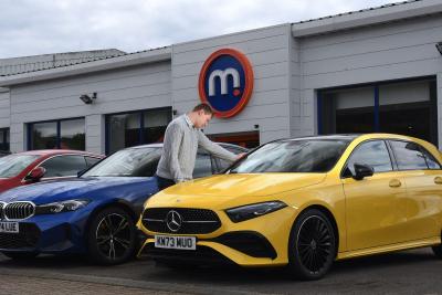 Customer checks price list of a used Mercedes A Class for financing options