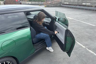 Eleanor getting out of Mini Cooper Electric