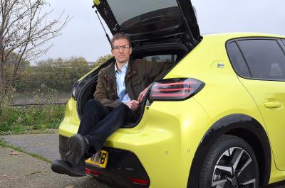 James Tute sitting in Peugeot e-208 boot