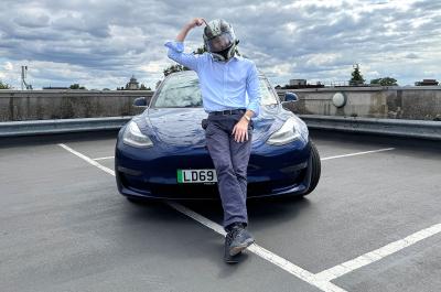 James Tute with crash helmet and Tesla Model 3 Performance