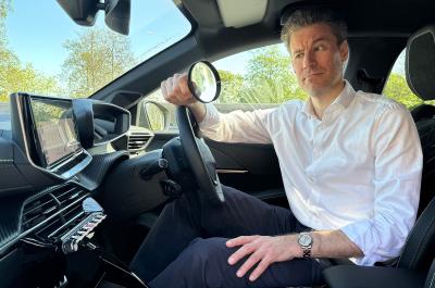 James Tute examining Peugeot e-208 interior