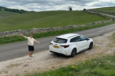Jonty posing next to his LT Toyota Corolla Touring Sports on a rural road