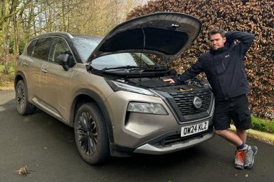 Jonty Renk looking inquisitive in front of long-term X-Trail with bonnet up