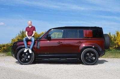 Land Rover Defender LT side with person sitting on bonnet