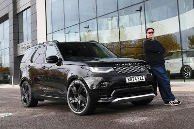 Land Rover Discovery LT outside showroom with person