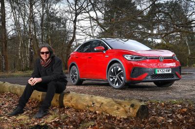 Volkswagen ID 5 with Mark sitting in front of it