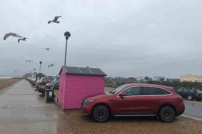 Mercedes EQC by the beach on a windy day
