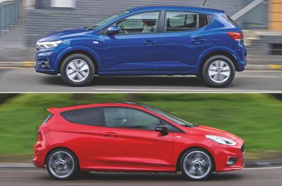 Dacia Sandero pictured driving from the side and Ford Fiesta pictured driving from the side