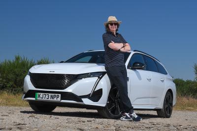 Peugeot e-308 SW Mark standing by car