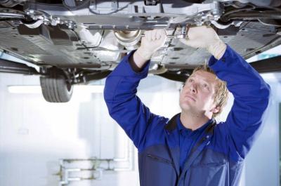 Technician servicing a car