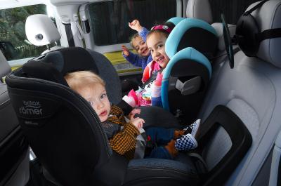 Three children in car child seats - side by side