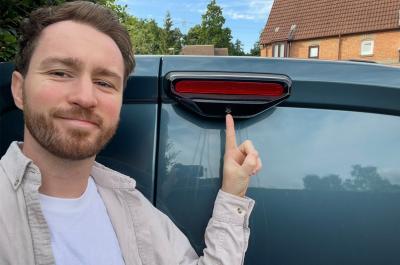 Tom pointing at the Fiat Doblo rear view camera